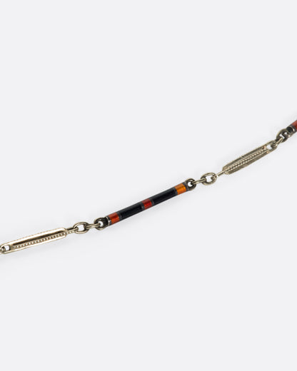 Vintage white gold and enamel bar link necklace, close view of a striped enamel bar