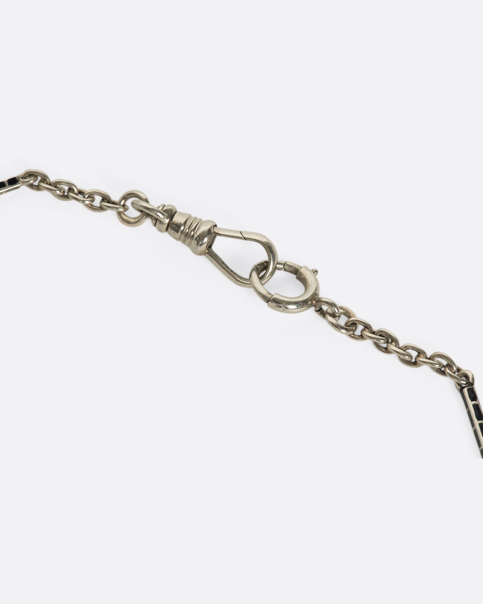 A vintage 14K white gold bar-link chain necklace with black enamel alternating throughout. Measuring just under 14 inches, this a dainty choker for someone with a slender neck.