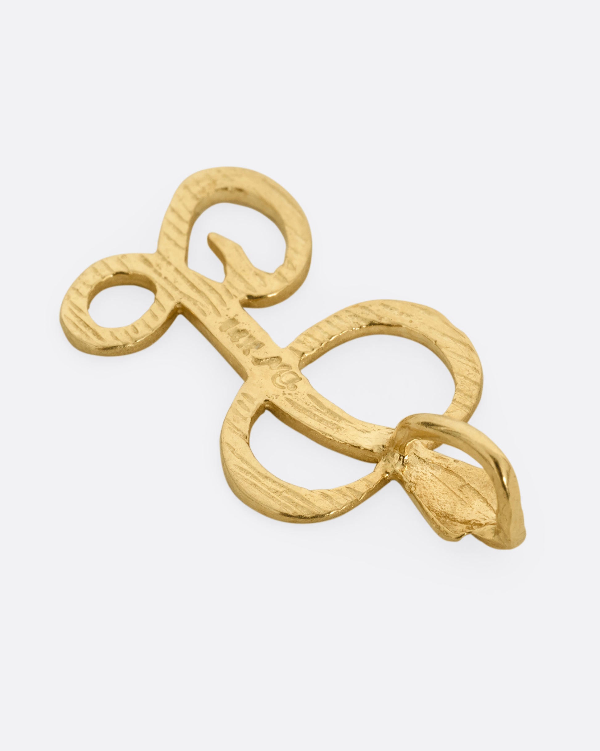A curling initial 'L' charm, shown from the back.