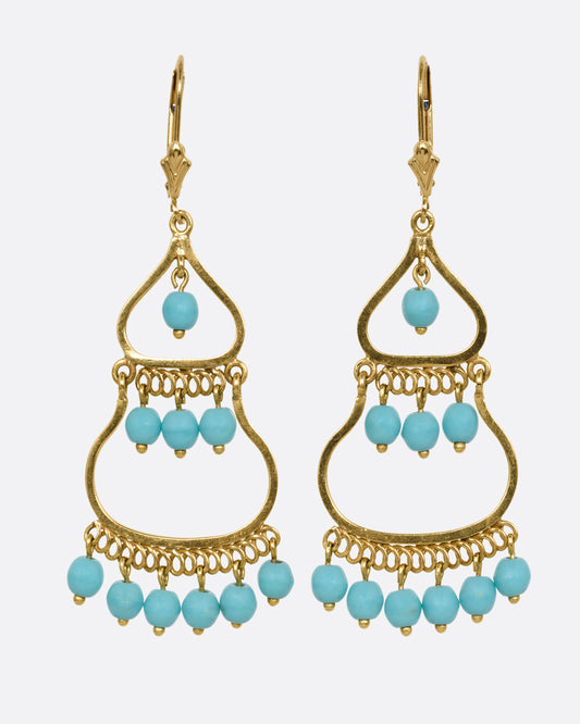 A pair of yellow gold  drop chandelier earrings with turquoise beads, shown from the front.