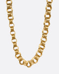 A yellow gold necklace with slanted stacked hoop links, shown from the front.