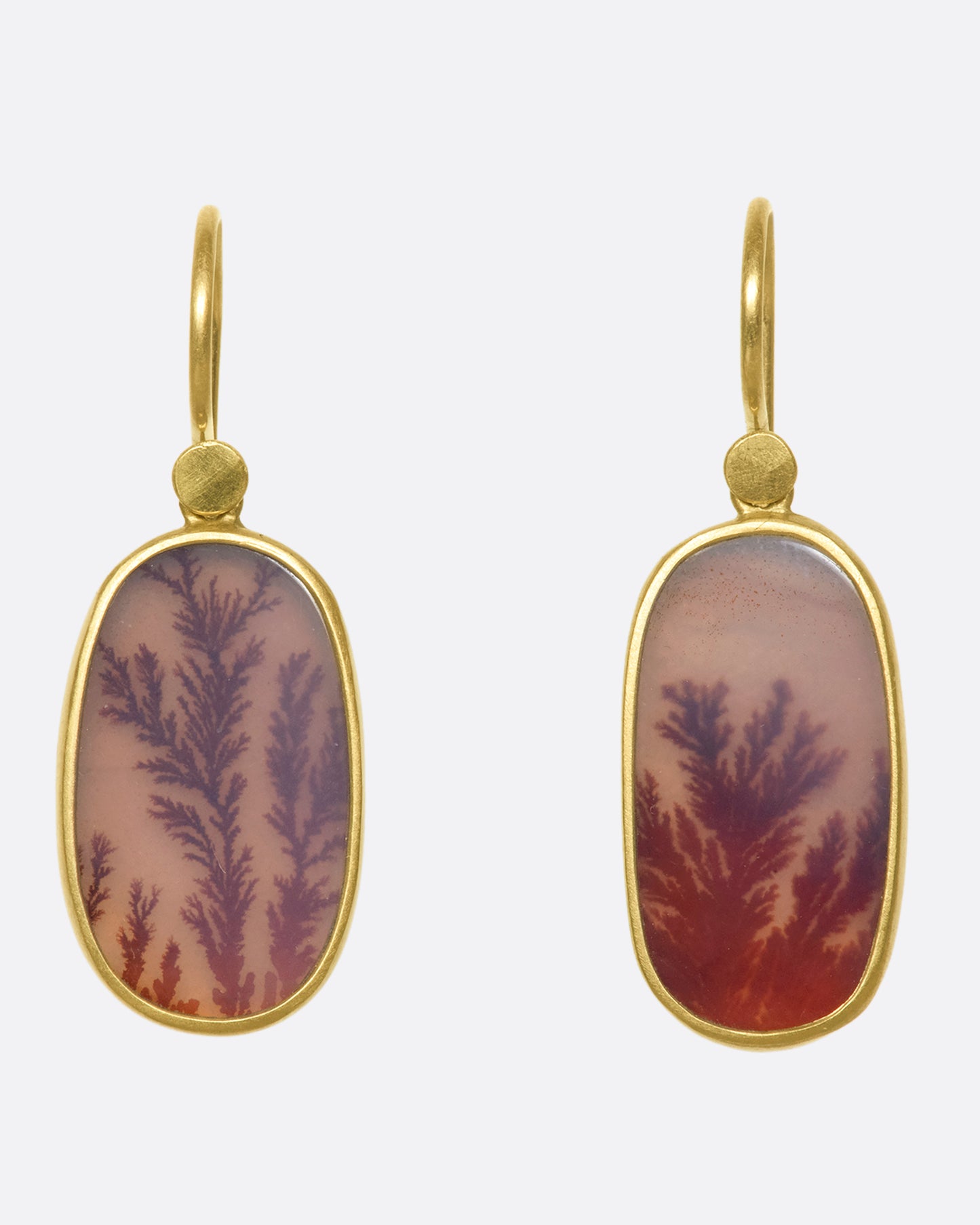 A pair of 18k gold drops with oval fiery dendritic agate stones. The tree-like occlusions swim in rosy pink light, adding a warm, glowing effect.