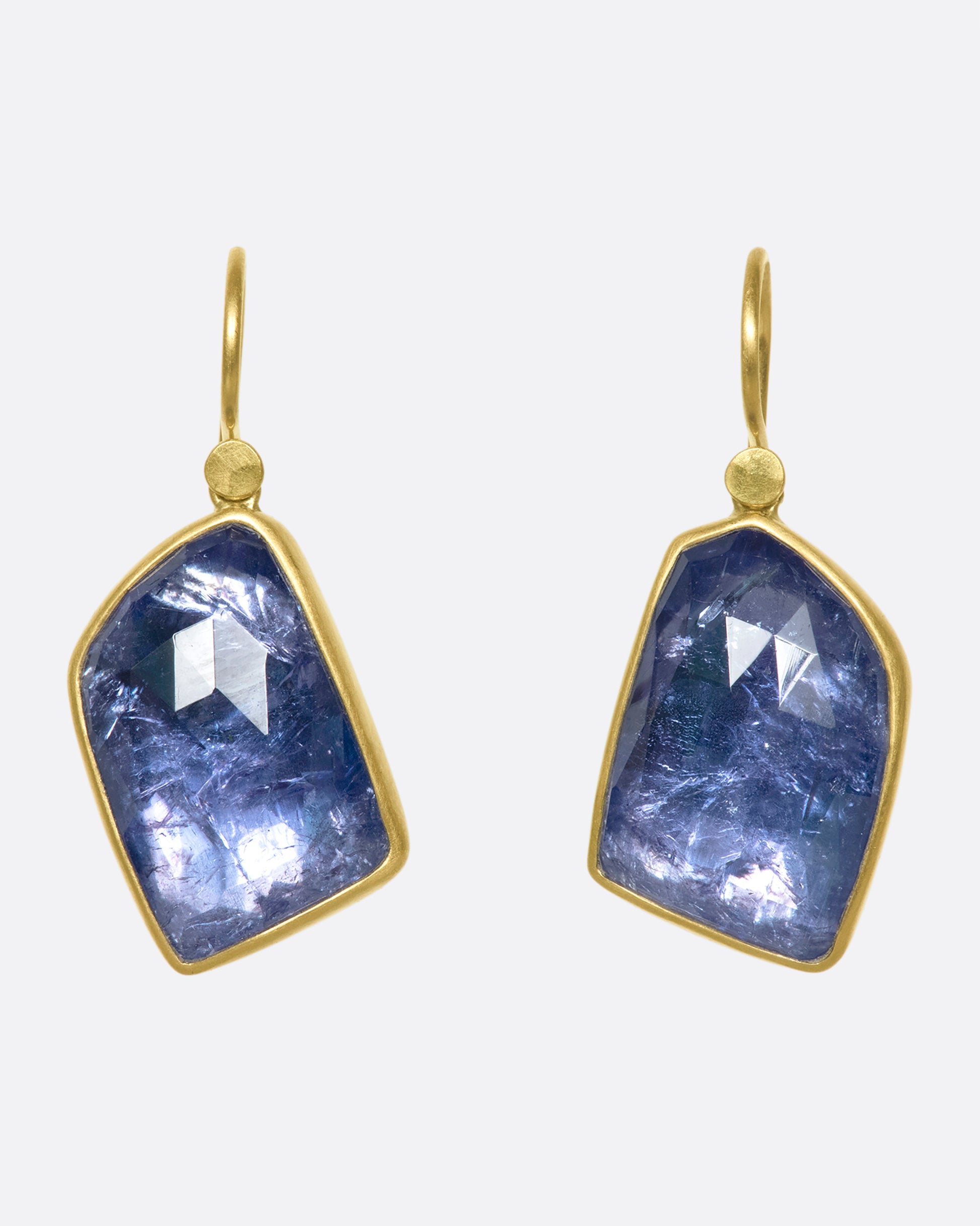 These rose cut asymmetrical tanzanite drop earrings have incredible movement within the stones and change with the light.
