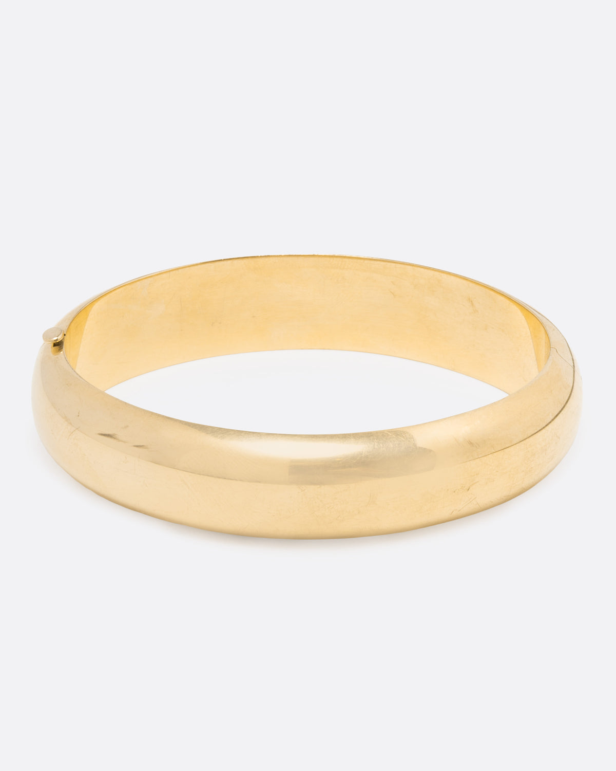 Vintage yellow gold cuff bracelet, angled view of the polished cuff showing the inside