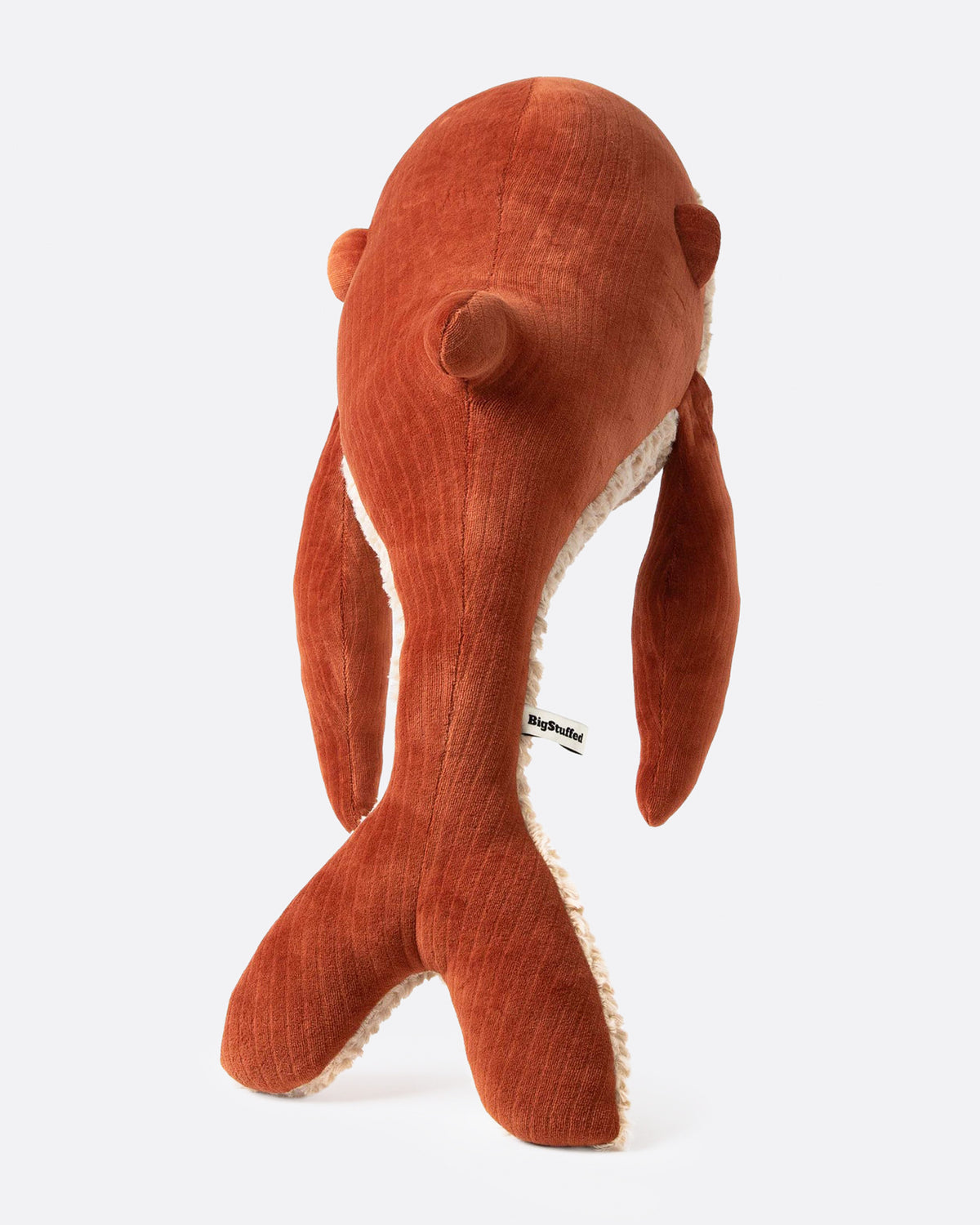 Red velvet stuffed whale shown from the back.