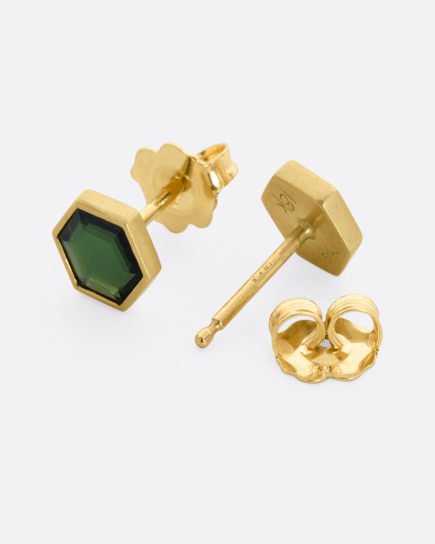 Yellow gold hexagon studs with bezel set green chrome tourmaline. View from the front and back alternating.