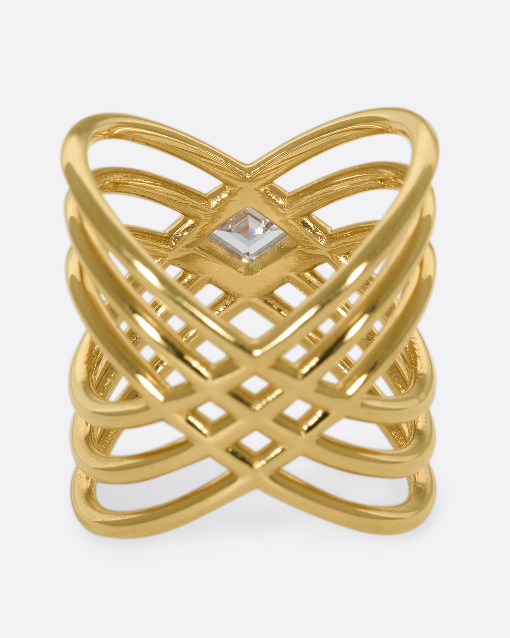 A vie of the underside of a multi banded X shaped ring with a lozenge shaped diamond in the center.