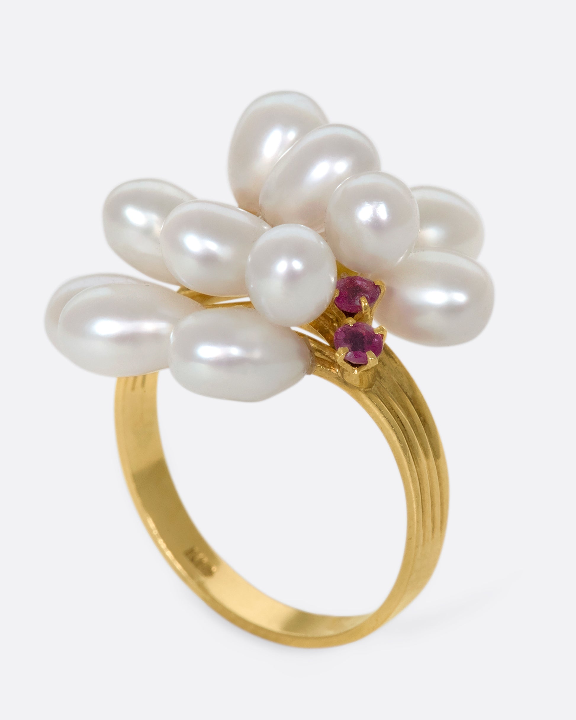 A 14k gold and pearl pussy willow ring with pink sapphire accents. Silky pearls wave across your finger like blossoms, adding beautiful dimension to your finger.
