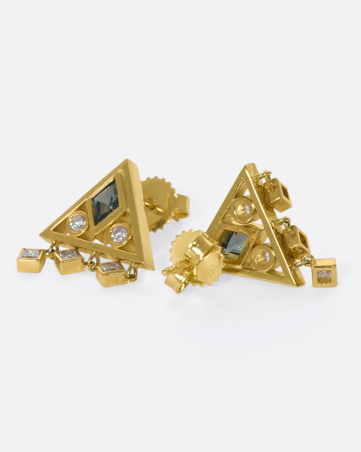 A gorgeously geometric pair of 14k gold triangle studs with teal sapphire lozenges and diamond accents