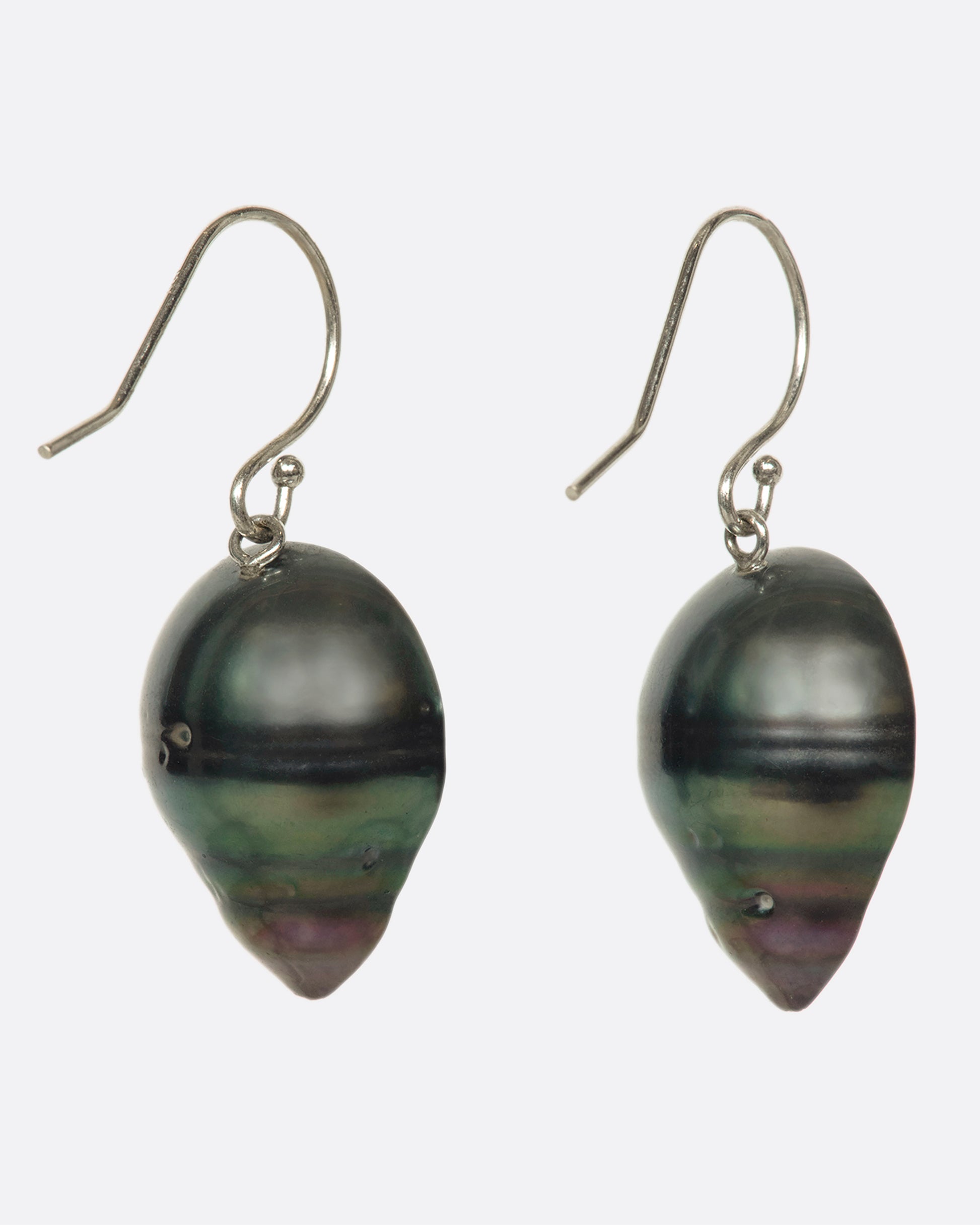 XA stunning pair of Tahitian baroque pearls with 14k white gold hooks. The black pearl with green and purple iridescence are lined with reclaimed black diamonds and full of wicked sparkle.