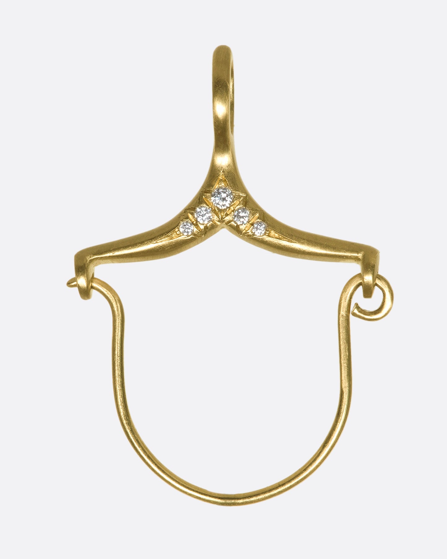 A gold and diamond charm holder close up.