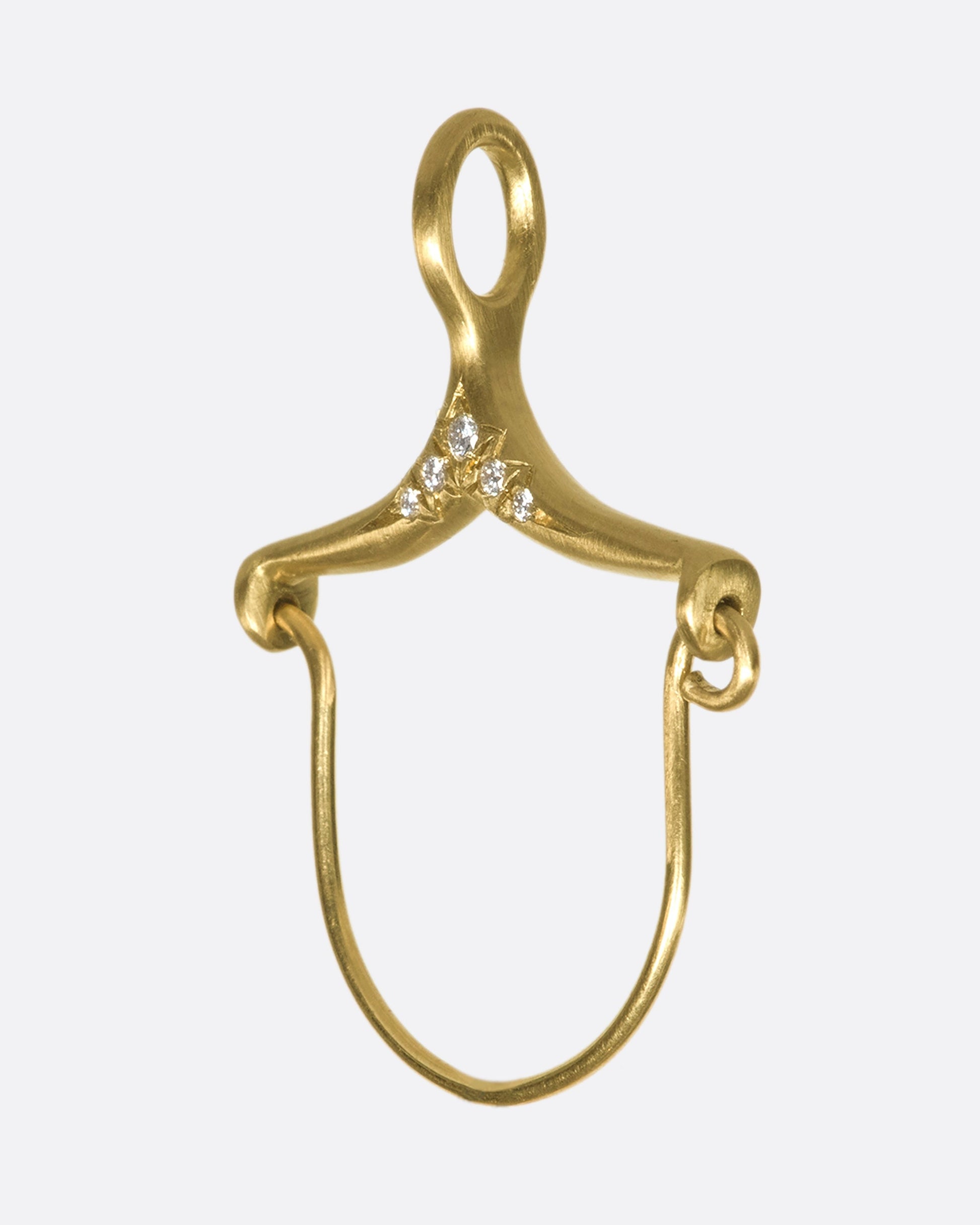 A gold and diamond charm holder from the side.