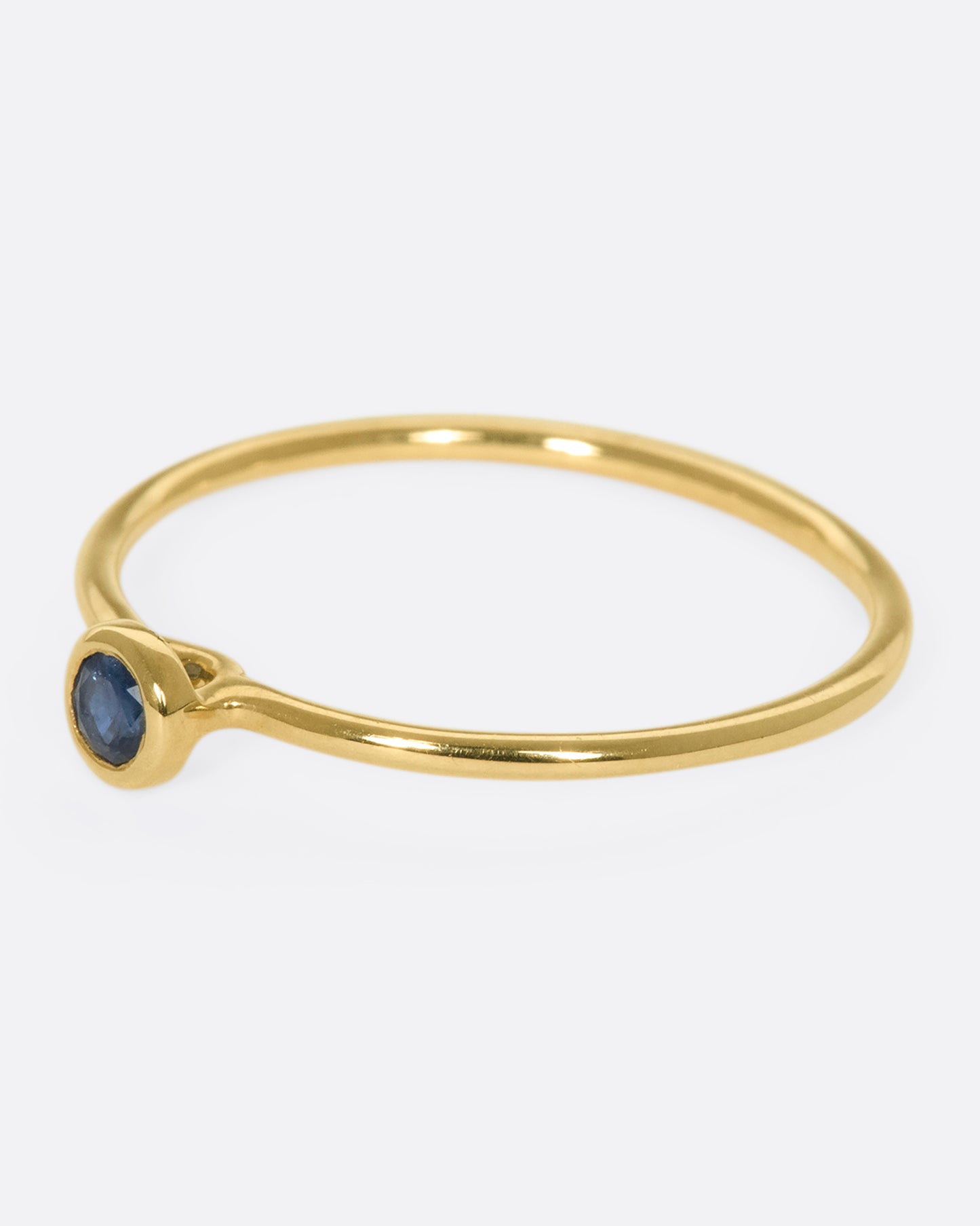Round blue sapphire set on a 9k gold ring