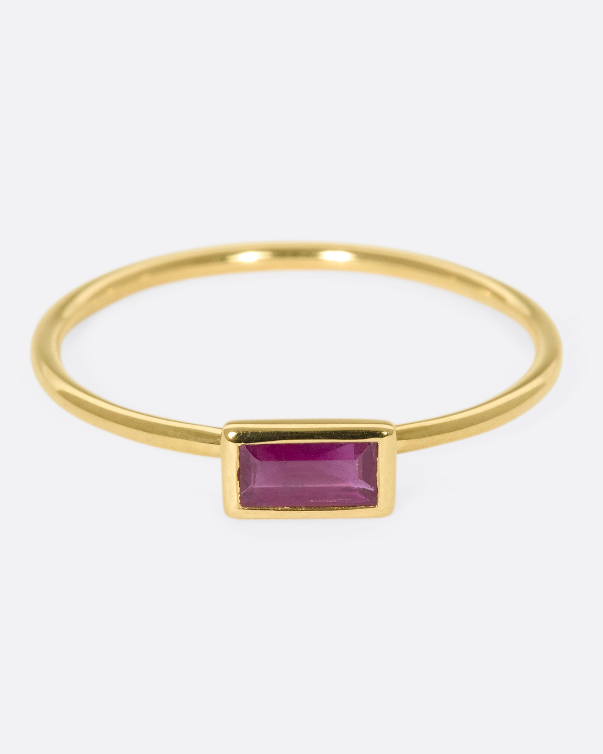 This horizontal ruby baguette set in 9k gold is a stunning stacker, adding color, sparkle, and dimensional interest without bringing any bulk.