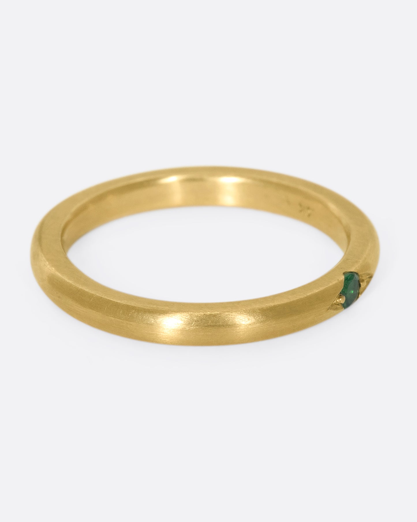 A 10k gold band with a single beautiful flush-set tsavorite garnet
