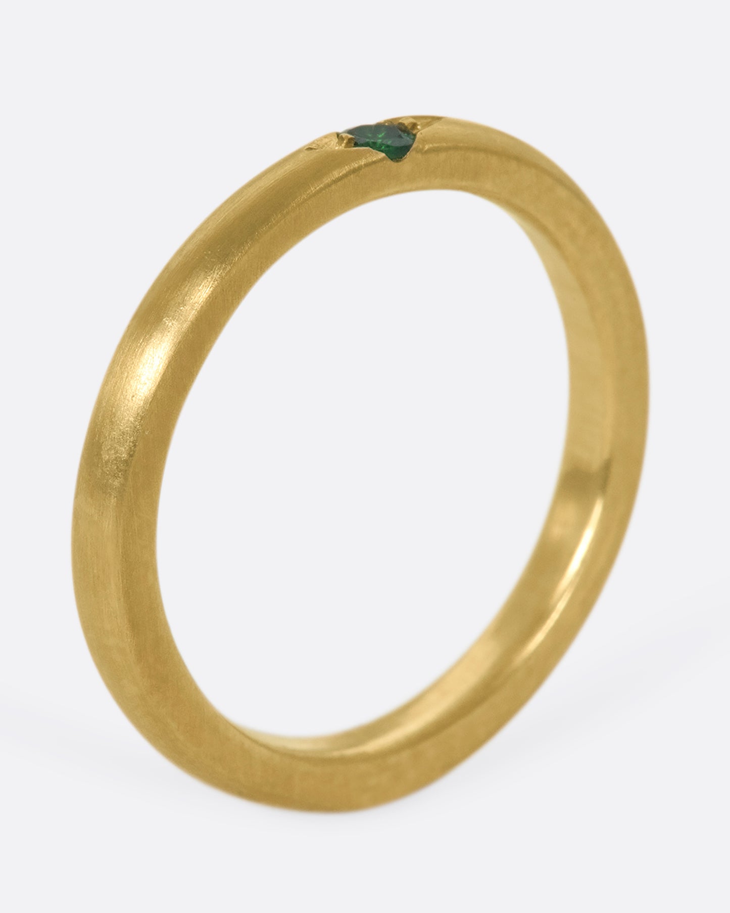 A 10k gold band with a single beautiful flush-set tsavorite garnet