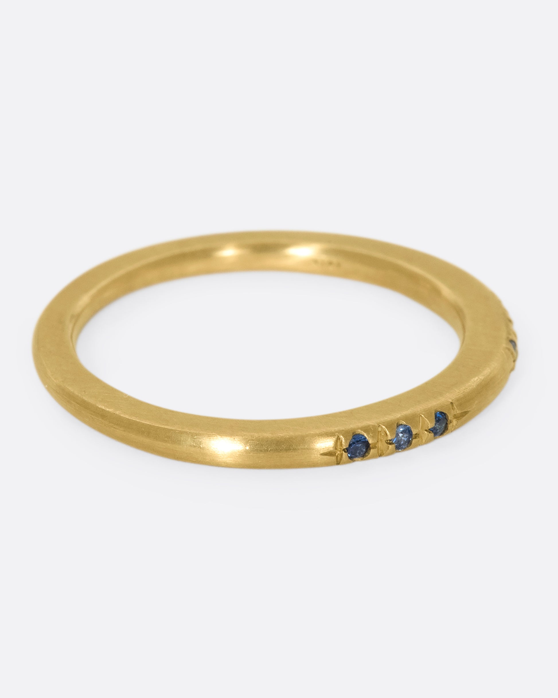 A 10k gold band with light and dark blue sapphires