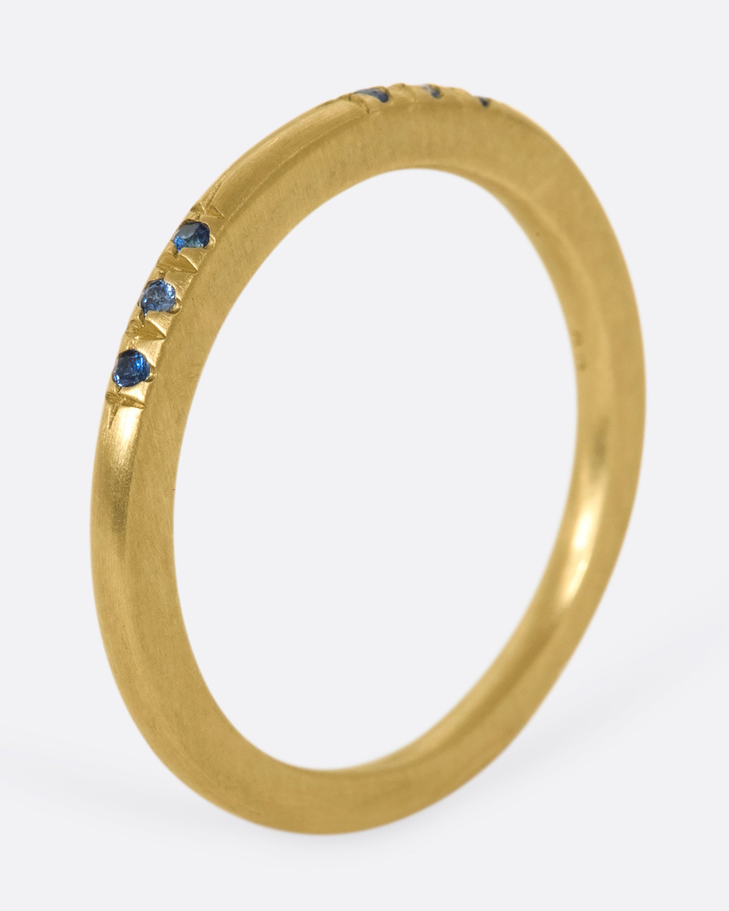 A 10k gold band with light and dark blue sapphires