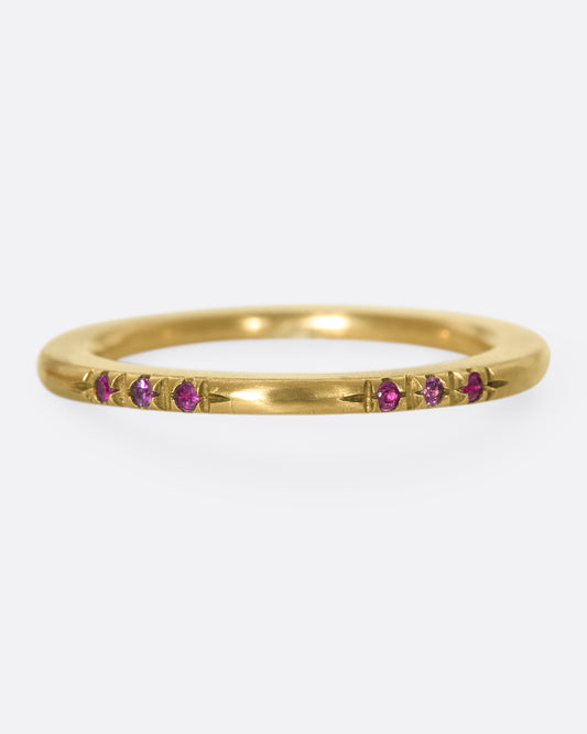 A 10k brushed gold band with rubies and pink sapphires