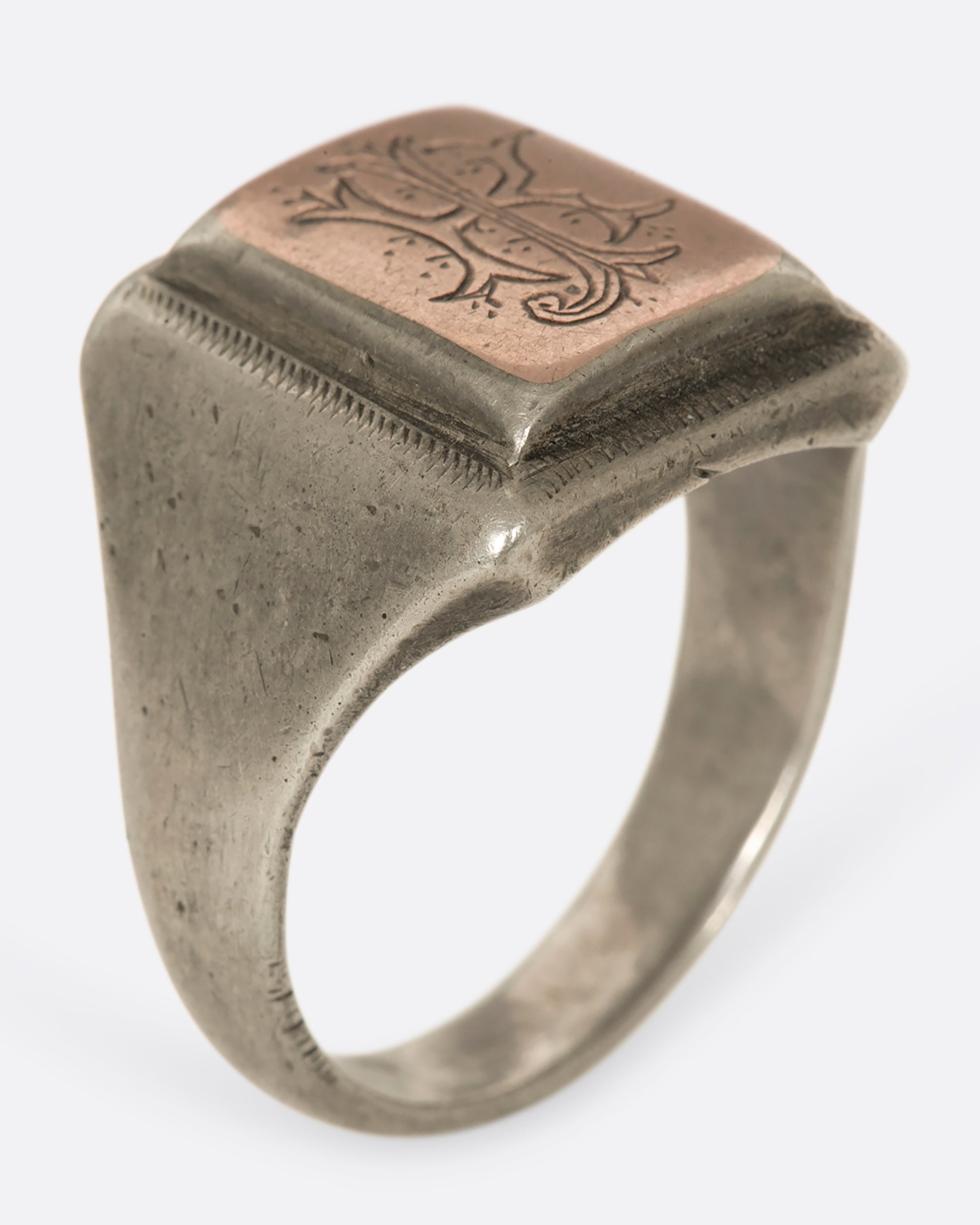 This square-faced 1940s sterling silver signet ring has a copper face with the initials RJ elegantly engraved. Gift accordingly. 