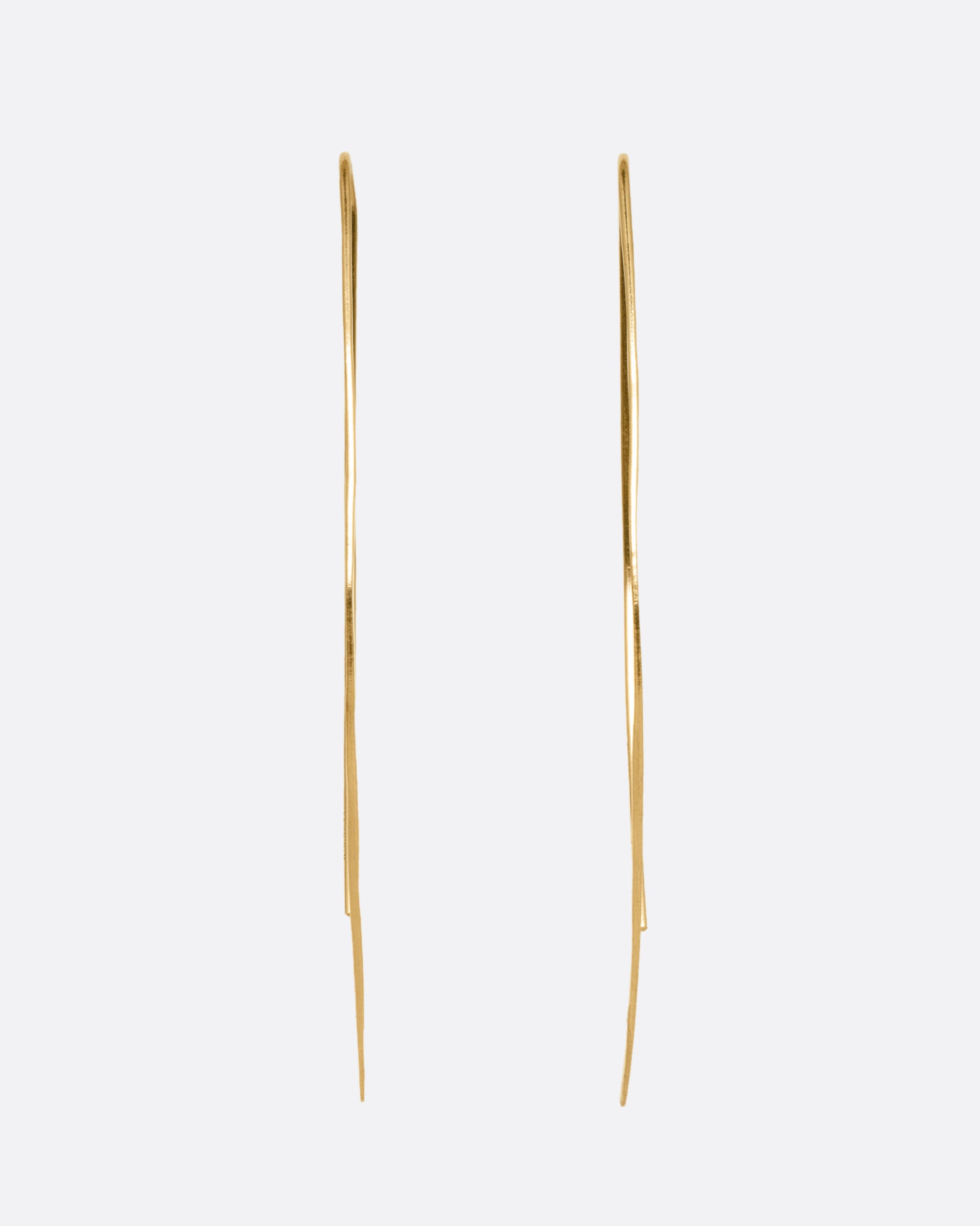 A pair of yellow gold angular hammered hook earrings. Shown from the front.