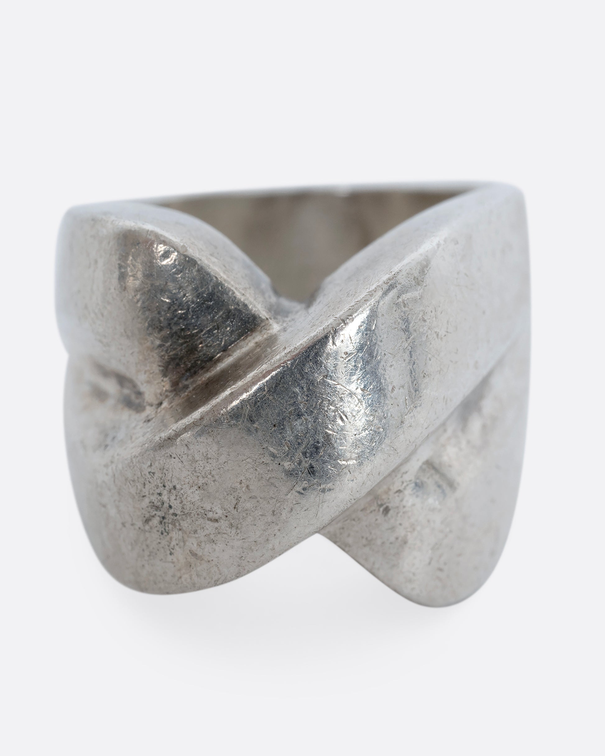 A sterling silver ring that criss crosses in the front. Shown from the front.