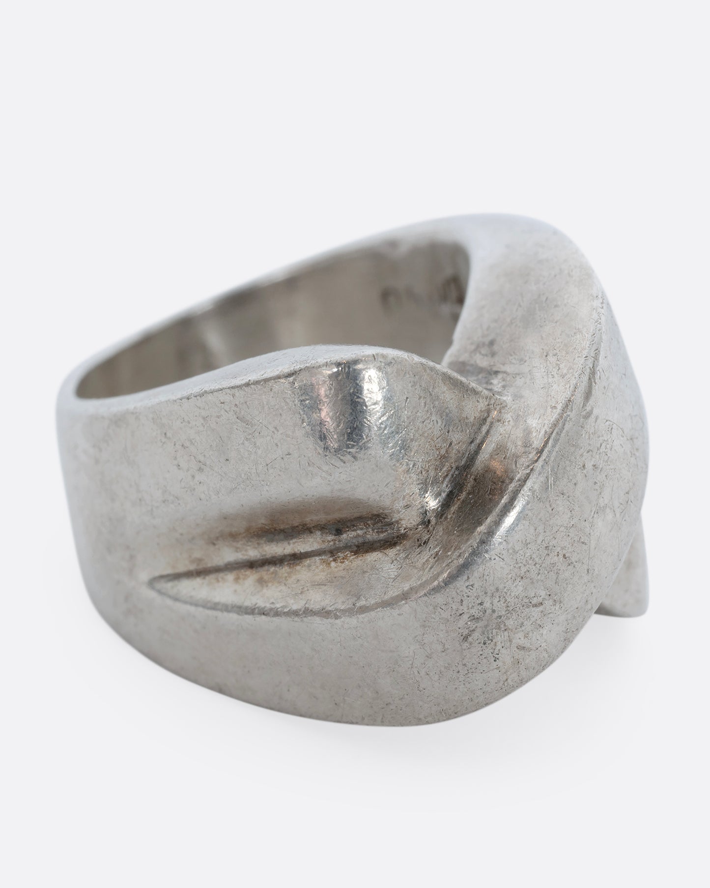 A sterling silver ring that criss crosses in the front. Shown from the alternate side.