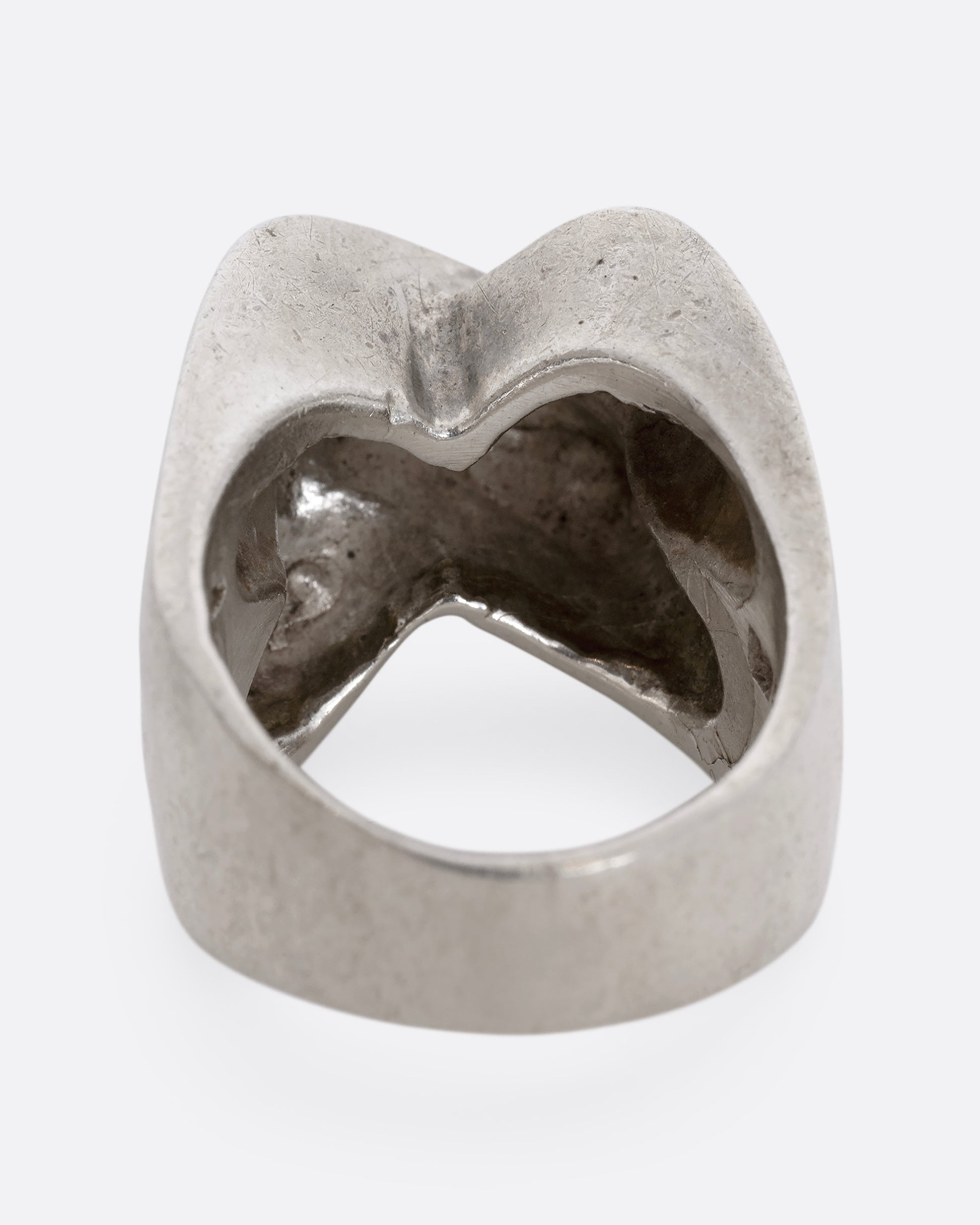 A sterling silver ring that criss crosses in the front. Shown from the back.