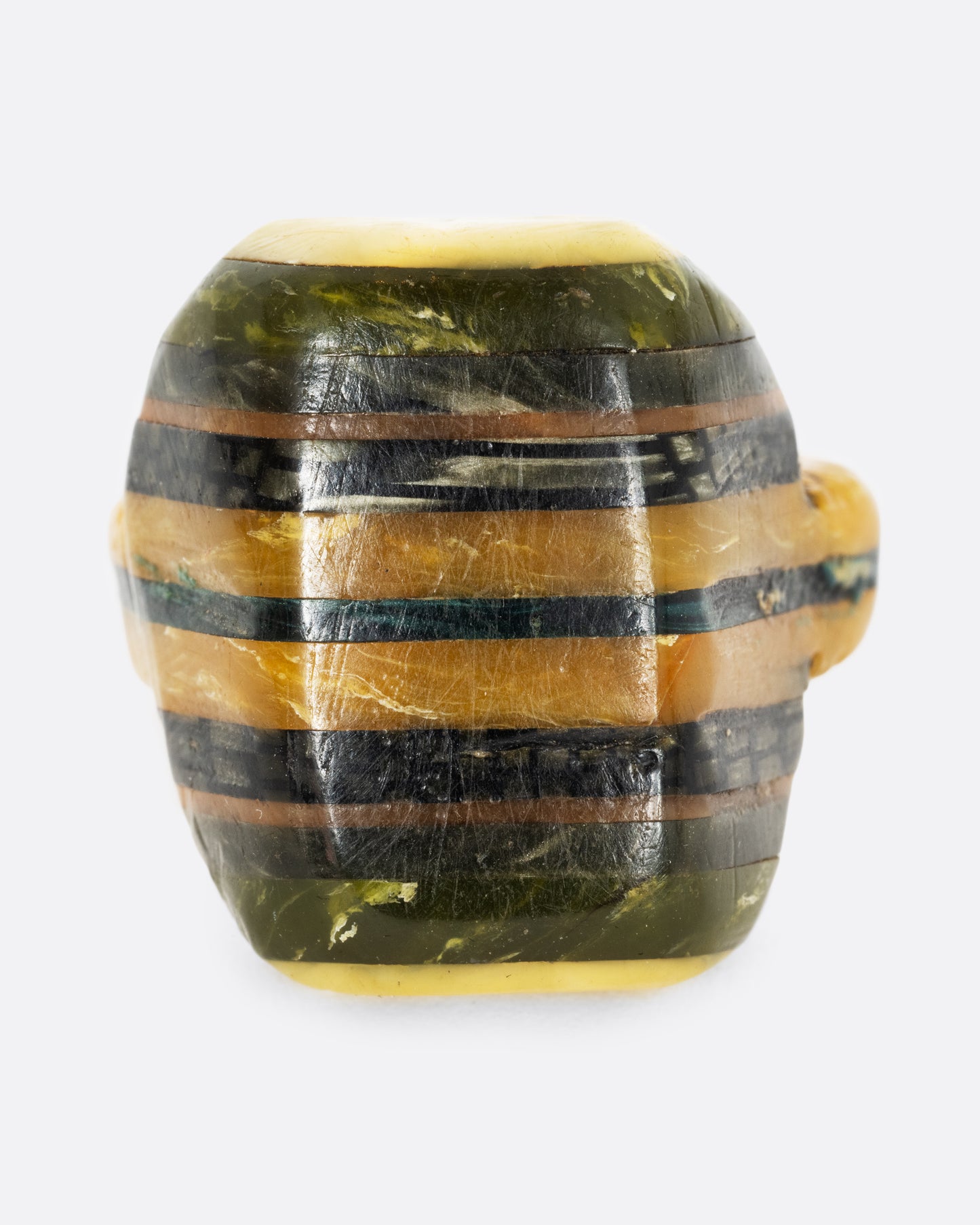 A green black and yellow composite celluloid prison art ring. Shown from the front.