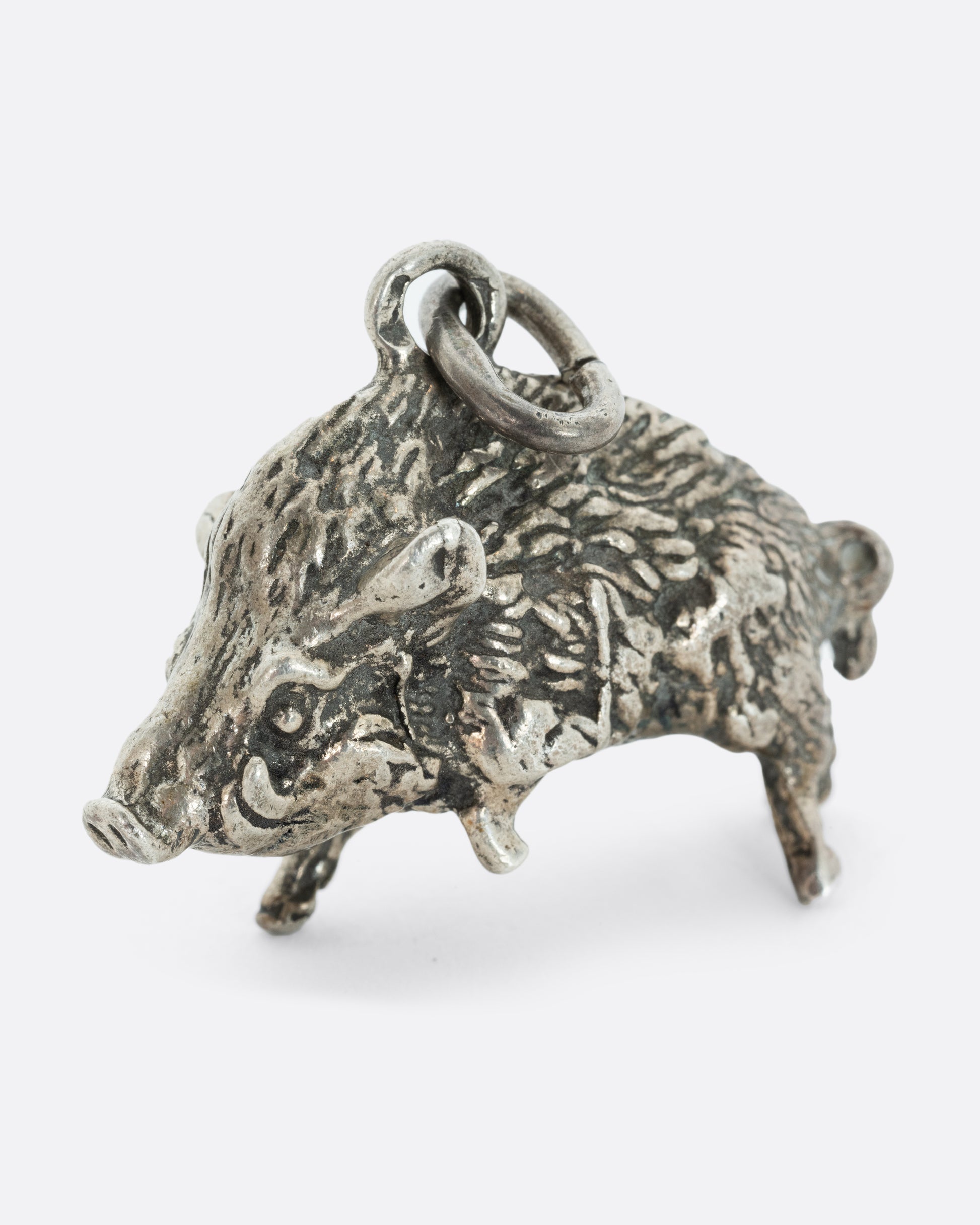 A sterling silver boar pendant.