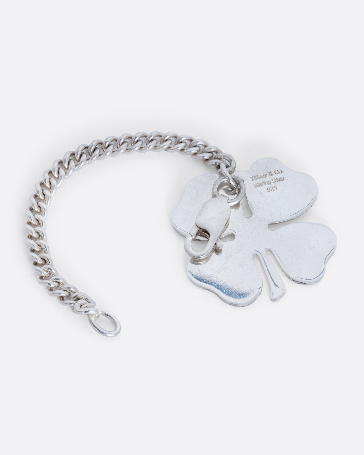 A sterling silver four leaf clover Tiffany and Co. keychain. View of the back.