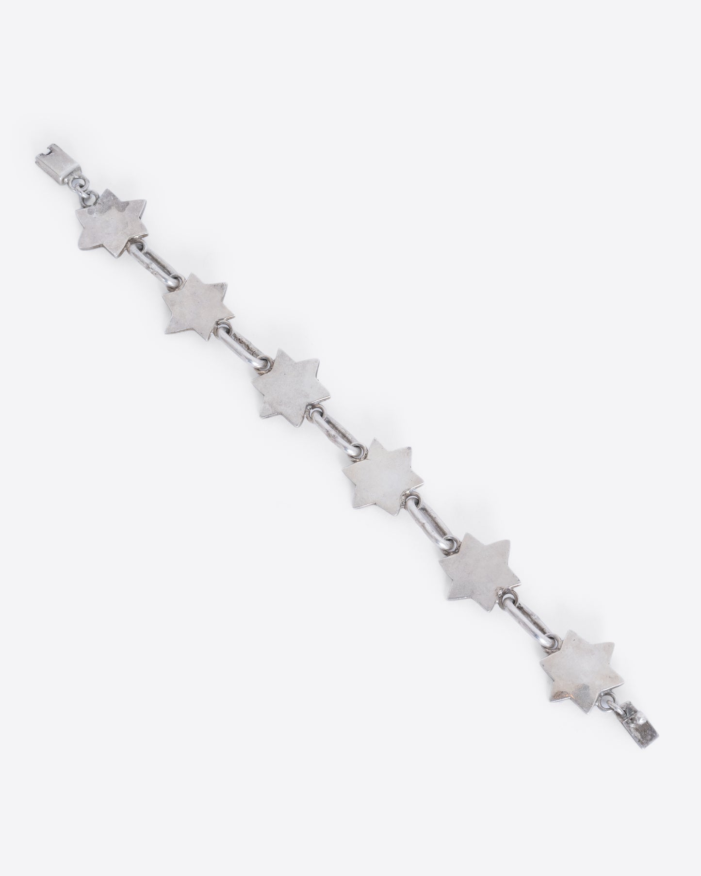 A sterling silver bracelet with star of David links. View laying flat from above.