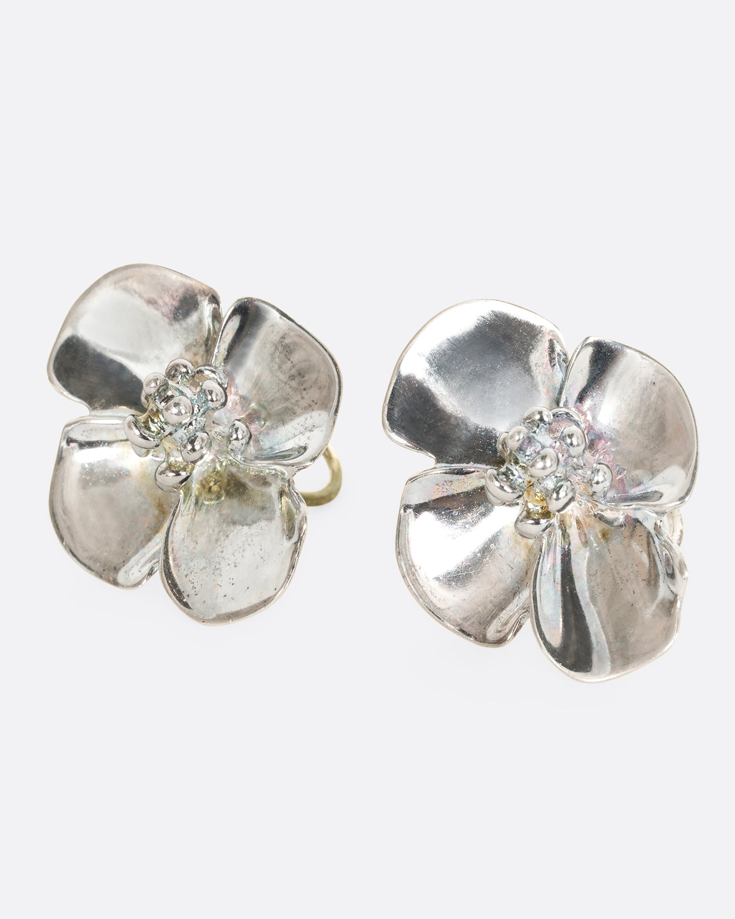 Sterling silver 3D flower clip on earrings. View from the side.