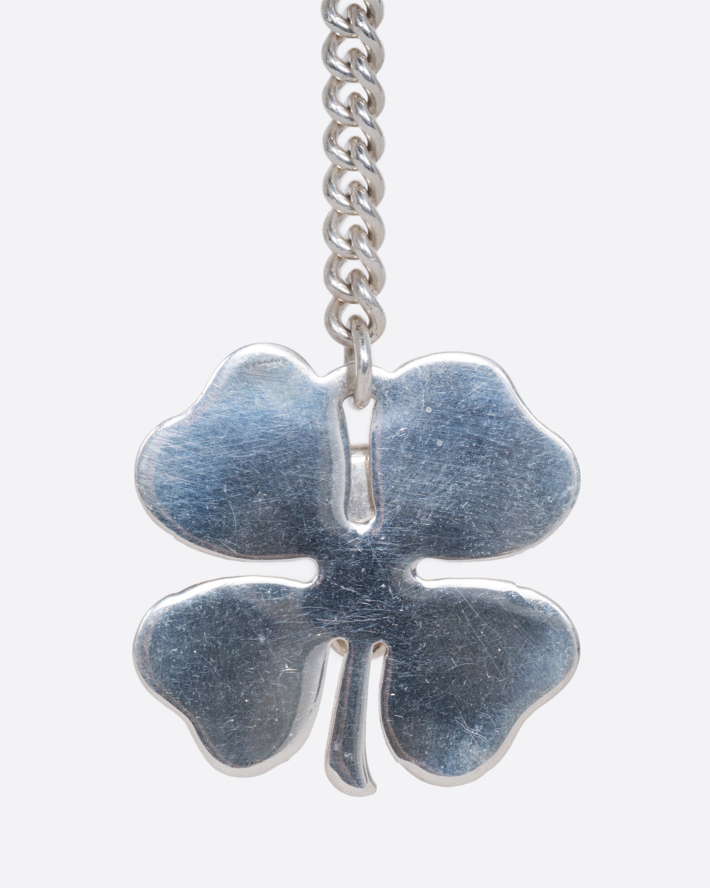 A sterling silver four leaf clover Tiffany and Co. keychain. View close up of the front.