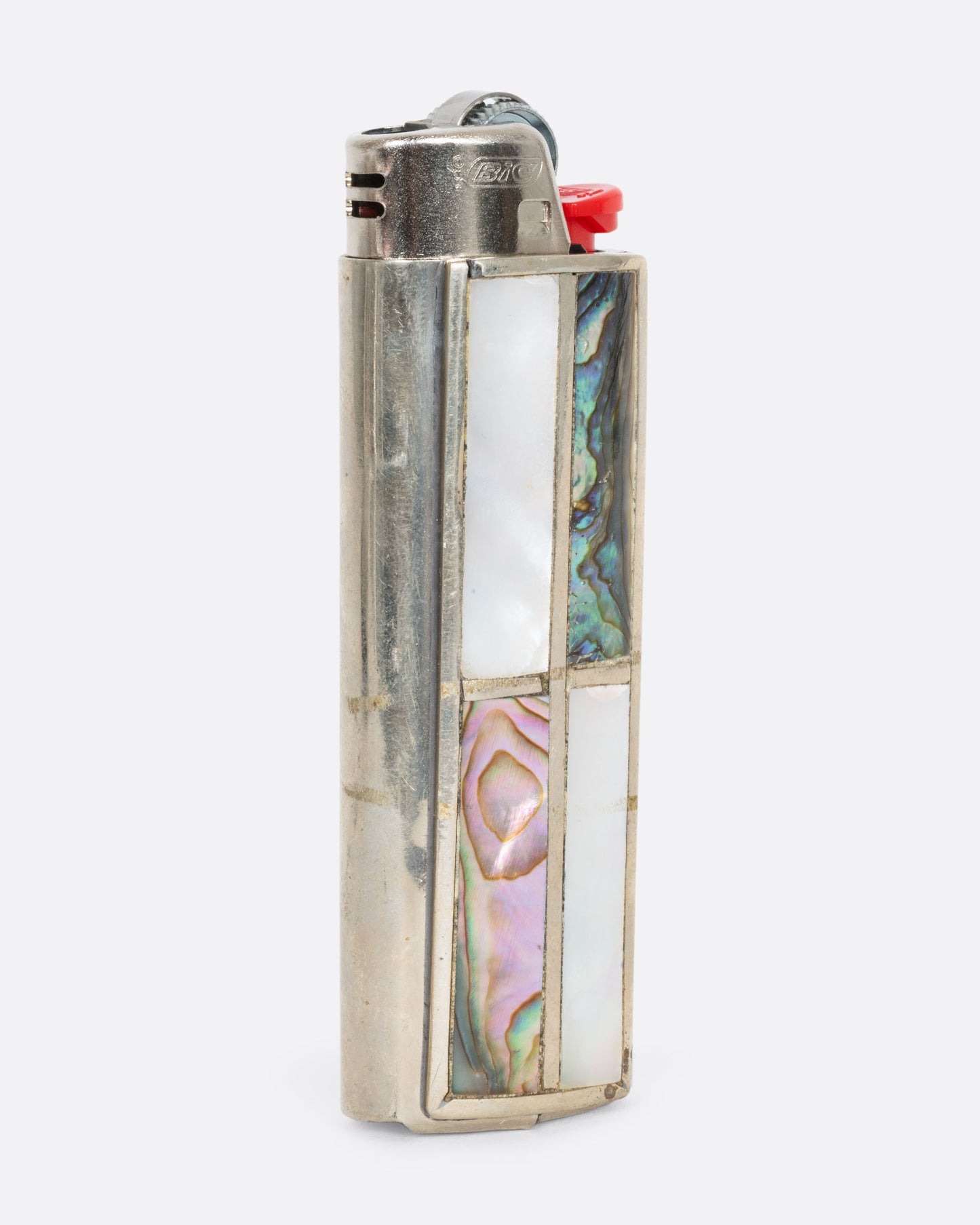 An alpaca silver lighter cover with mother of pearl and abalone. View from the side.