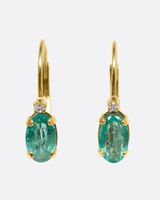 Yellow gold emerald and diamond drop earrings. View from the front.