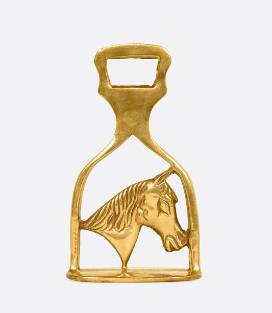 A brass horse bottle opener. Shown from the front.