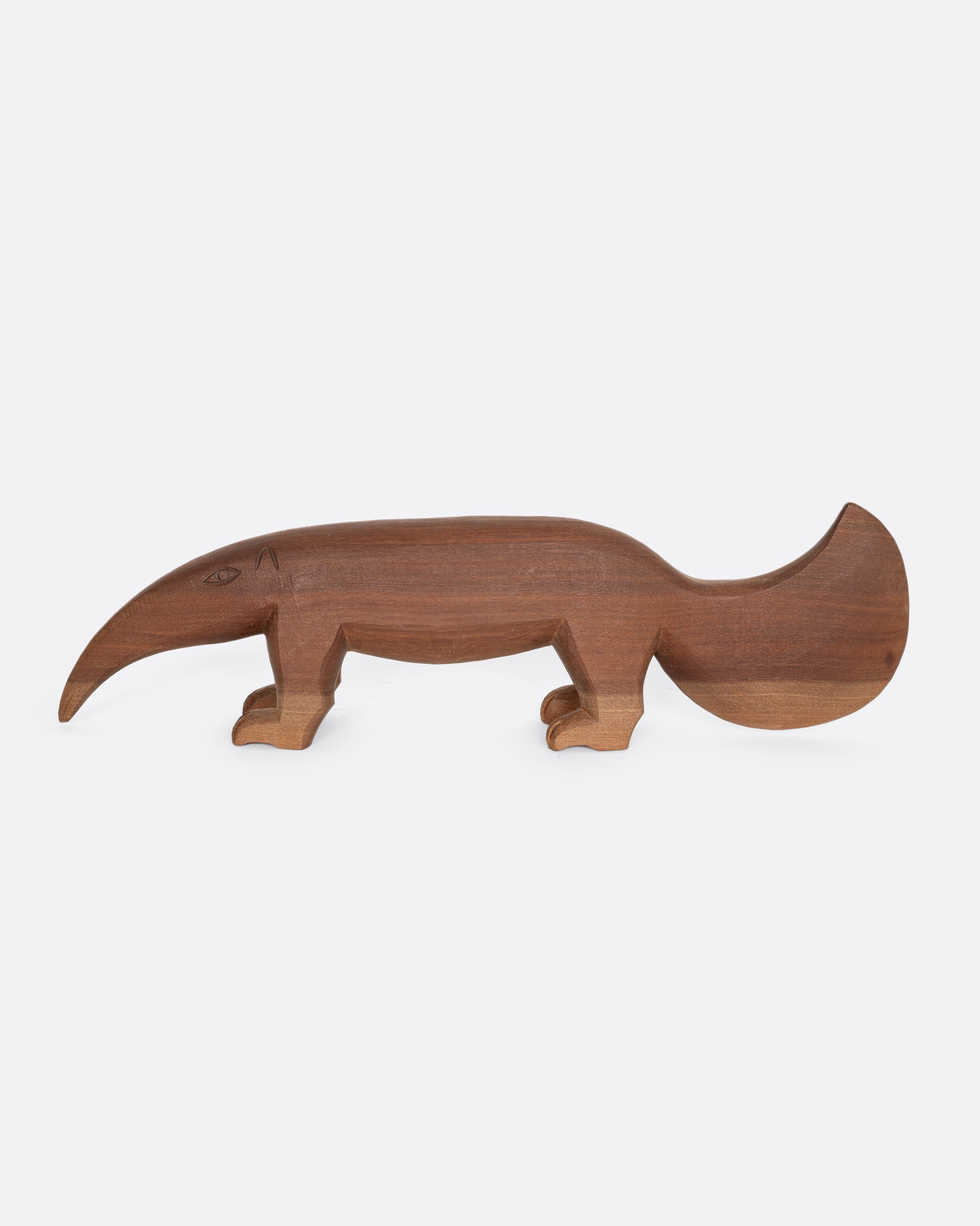 A hand carved wooden aardvark. Shown from the side.