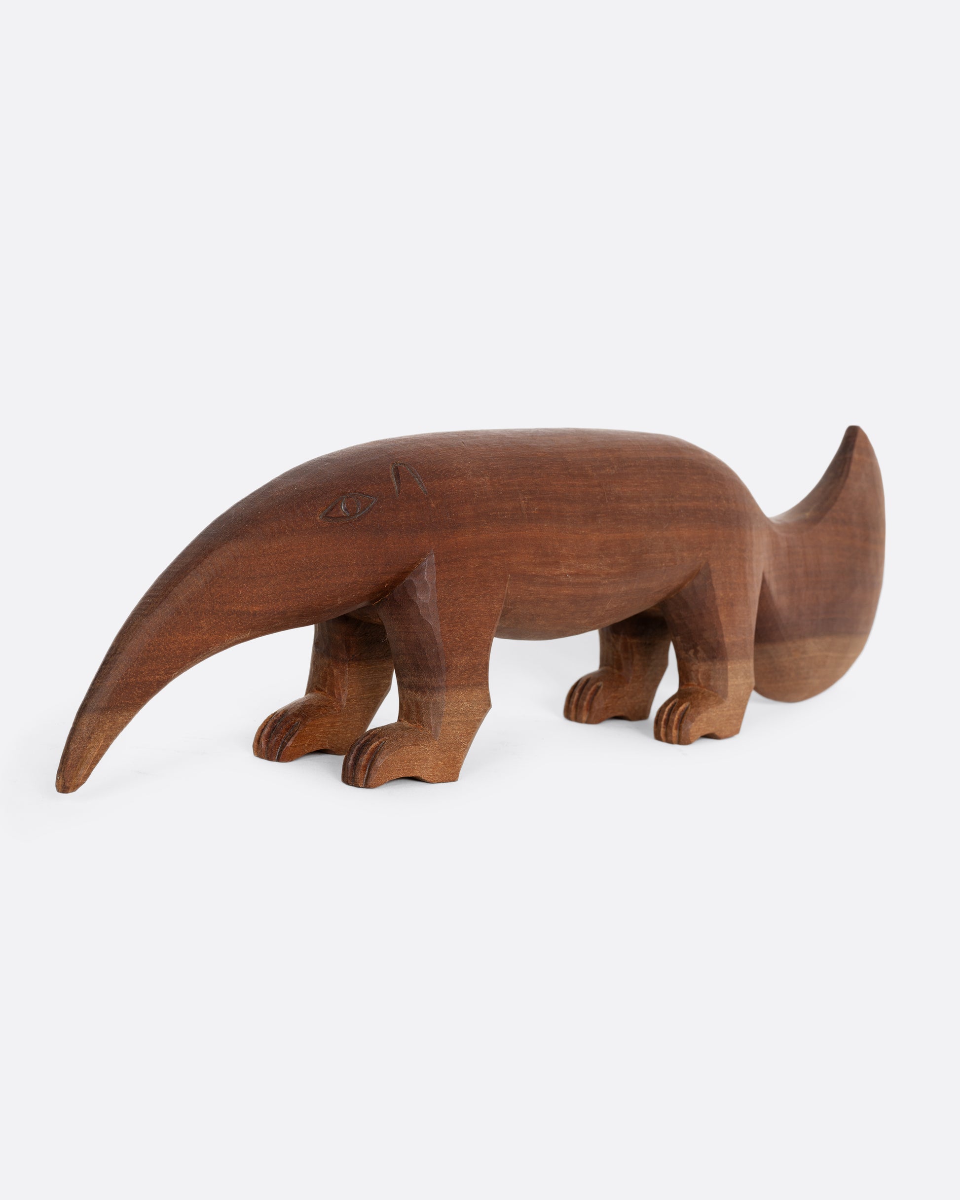 A hand carved wooden aardvark. Shown from the front.