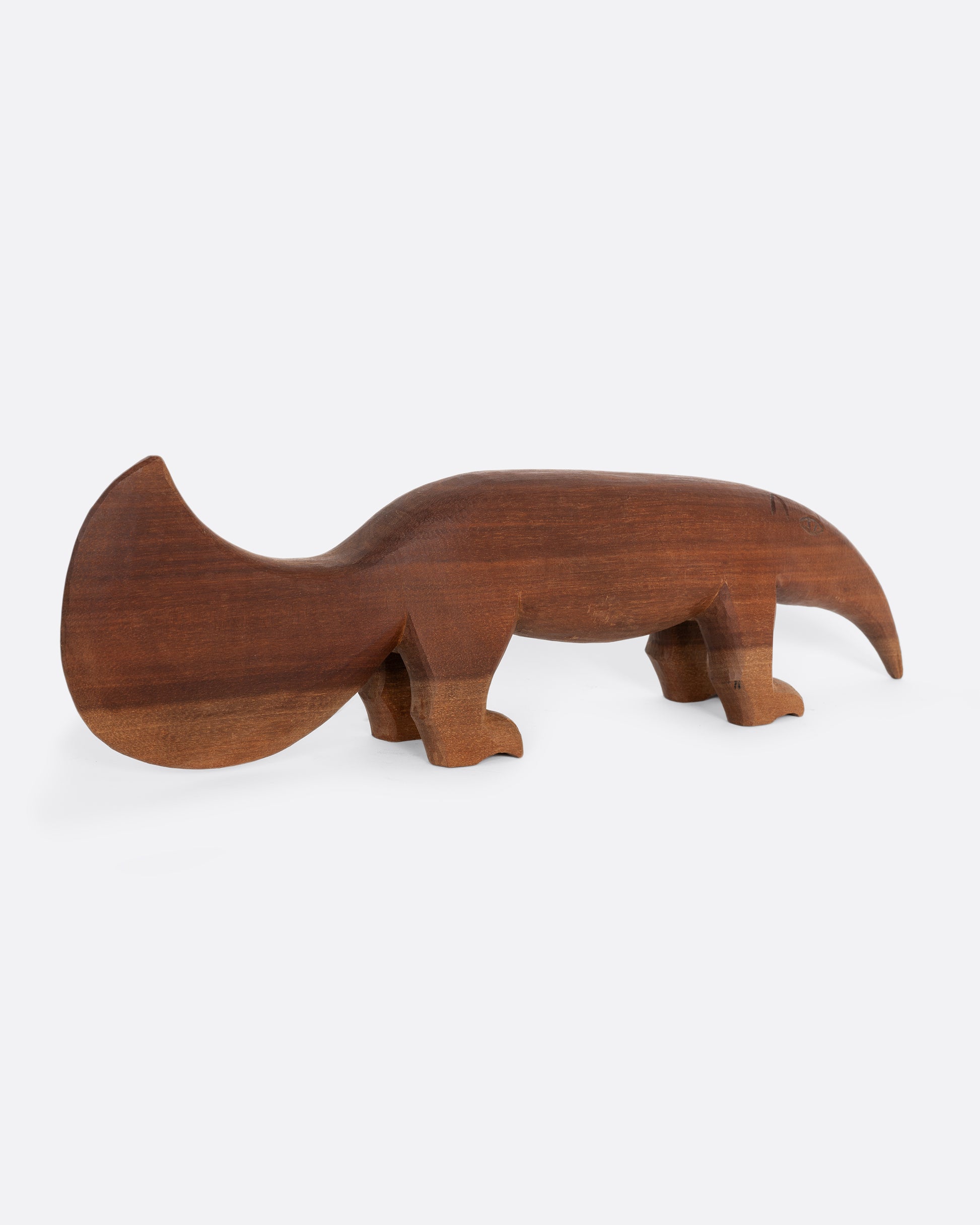 A hand carved wooden aardvark. Shown from the back.