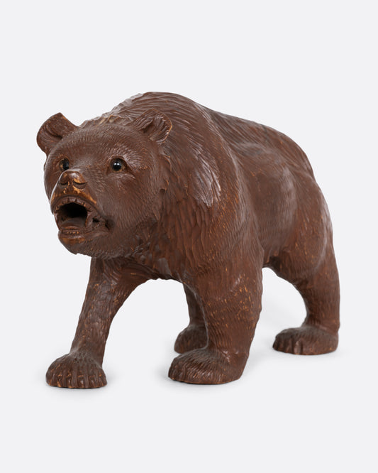 A wooden bear with glass eyes. Shown from the front.