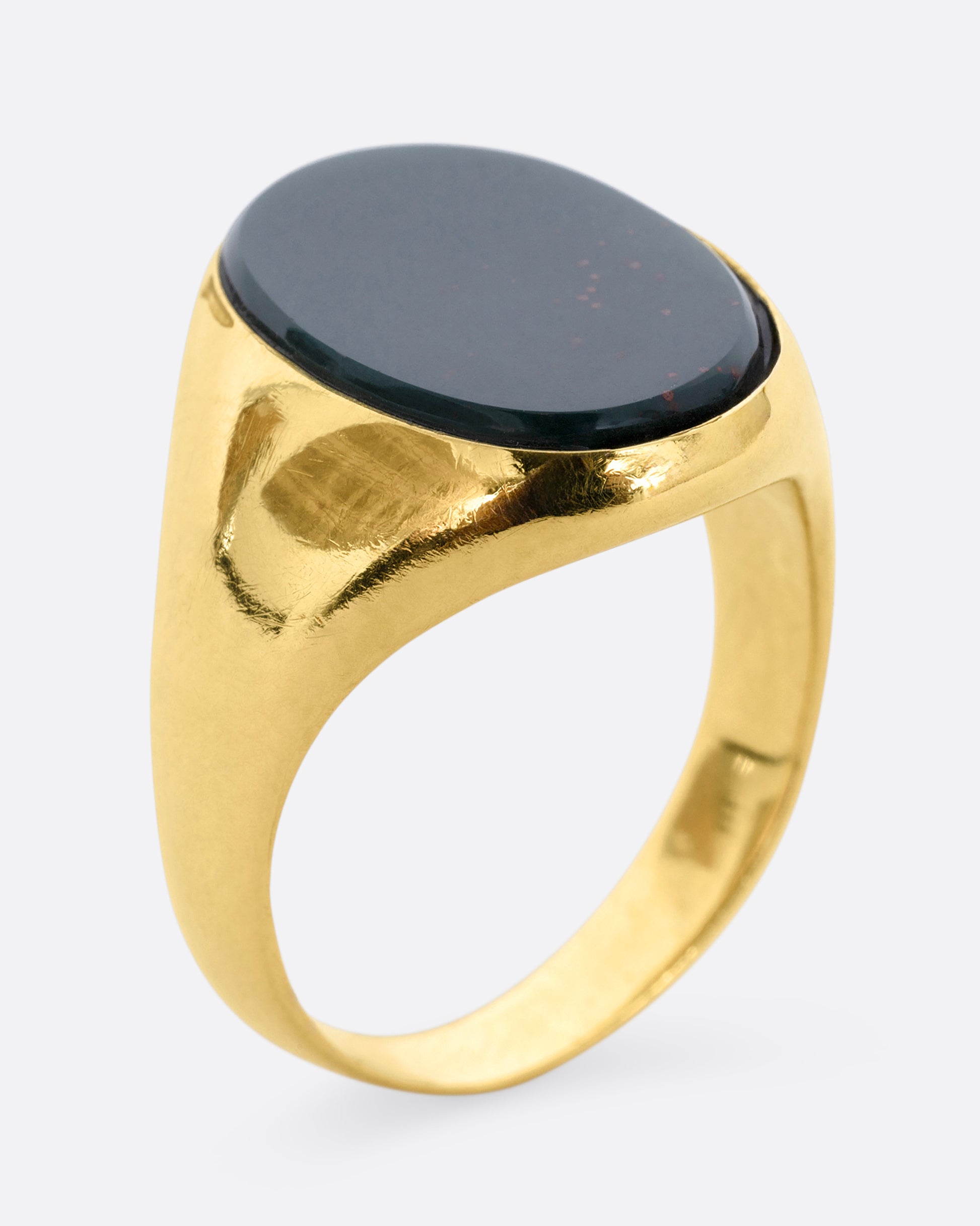 A yellow gold bloodstone signet ring. View from the side standing up.