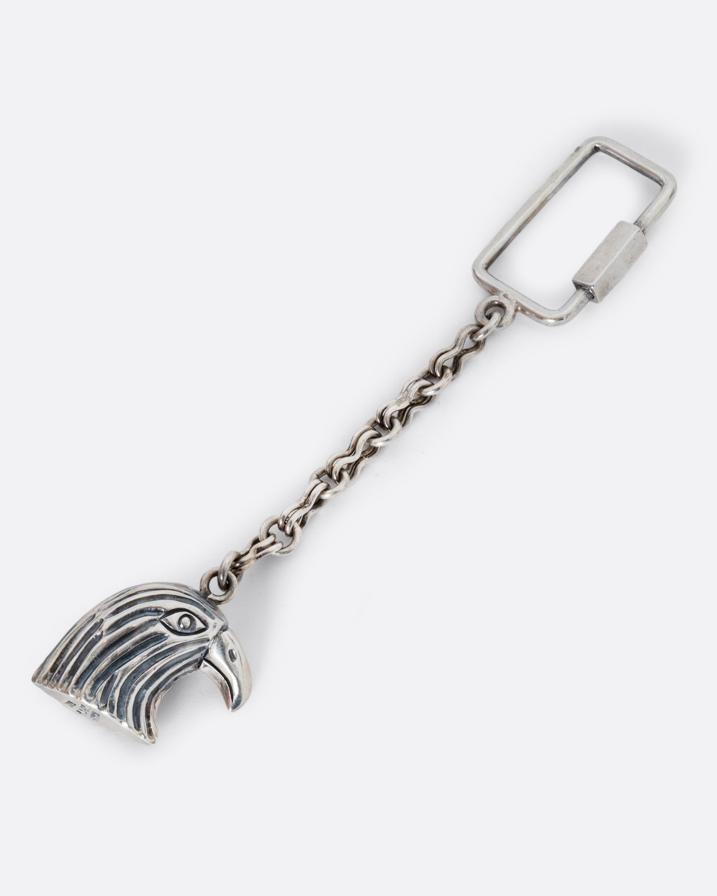 A sterling silver eagle keychain. Shown laying flat.