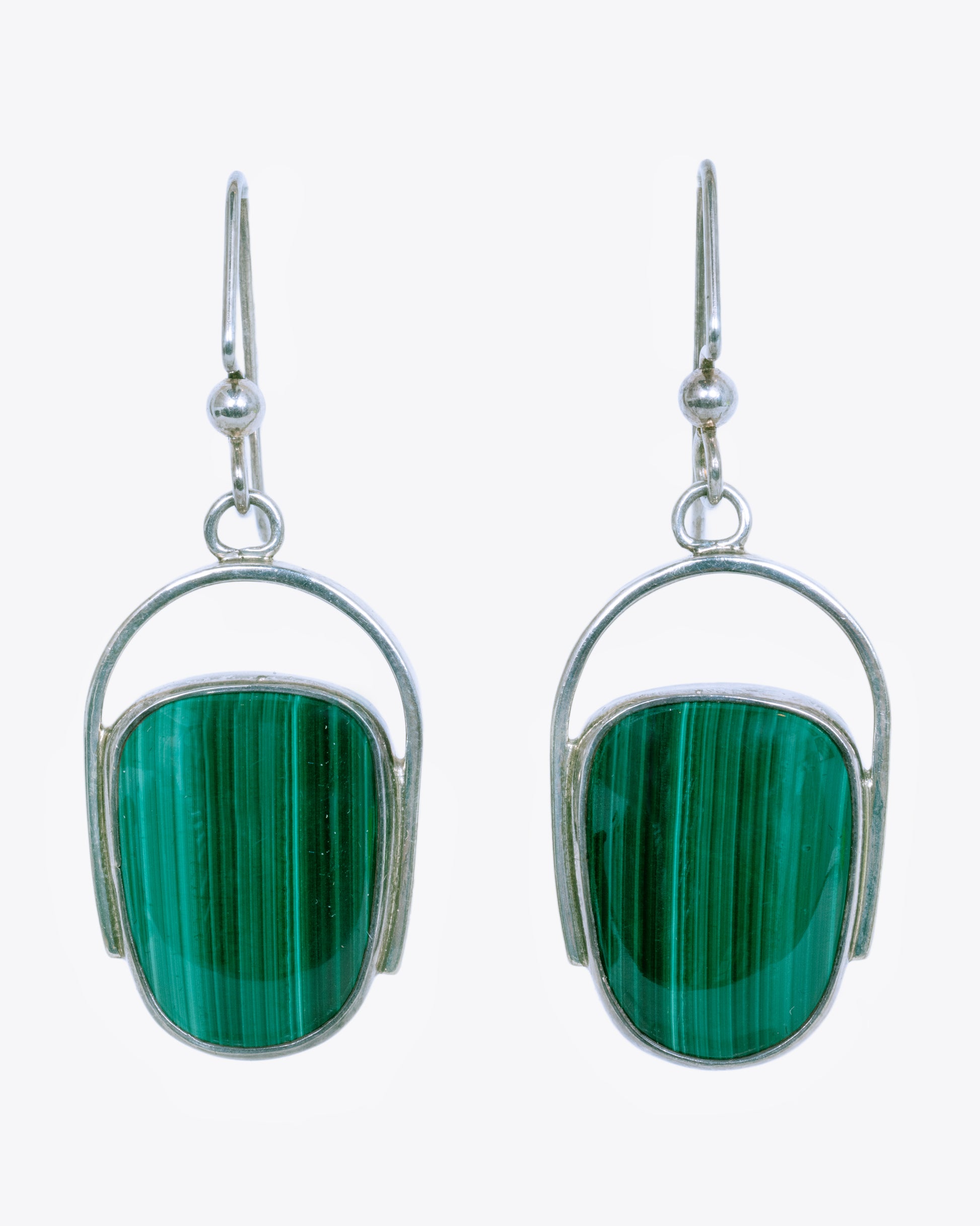 Sterling silver curved drop earrings with malachite. View from the front.