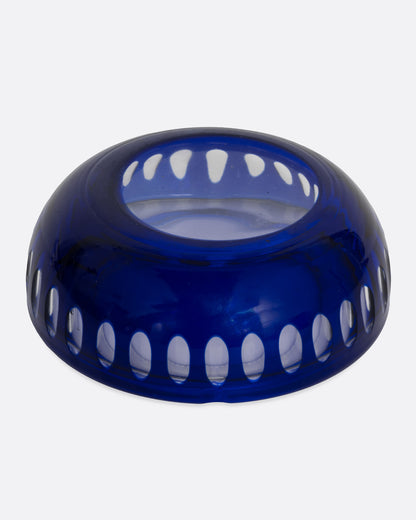 A blue glass ashtray with a bubbly design, shown from the bottom.