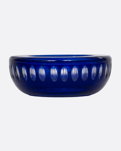 A blue glass ashtray with a bubbly design, shown from the front.