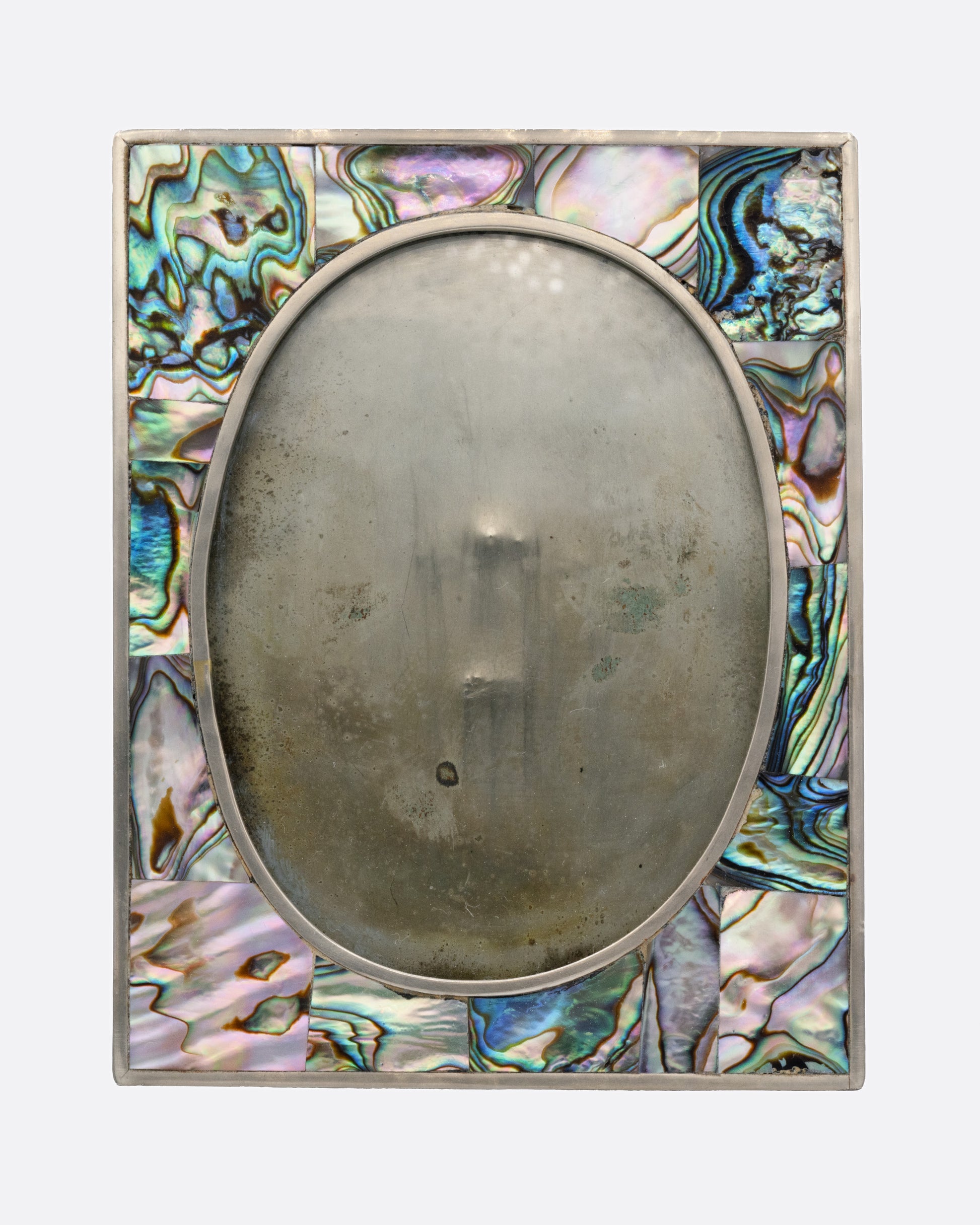 A rectangular silver frame with abalone inlay and an oval center. Shown from the front.