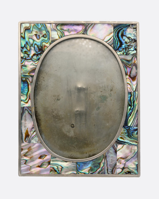 A rectangular silver frame with abalone inlay and an oval center. Shown from the front.