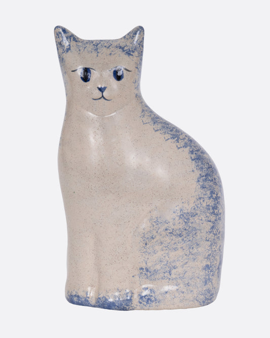 A ceramic cat figurine with blue speckles, shown from the front.