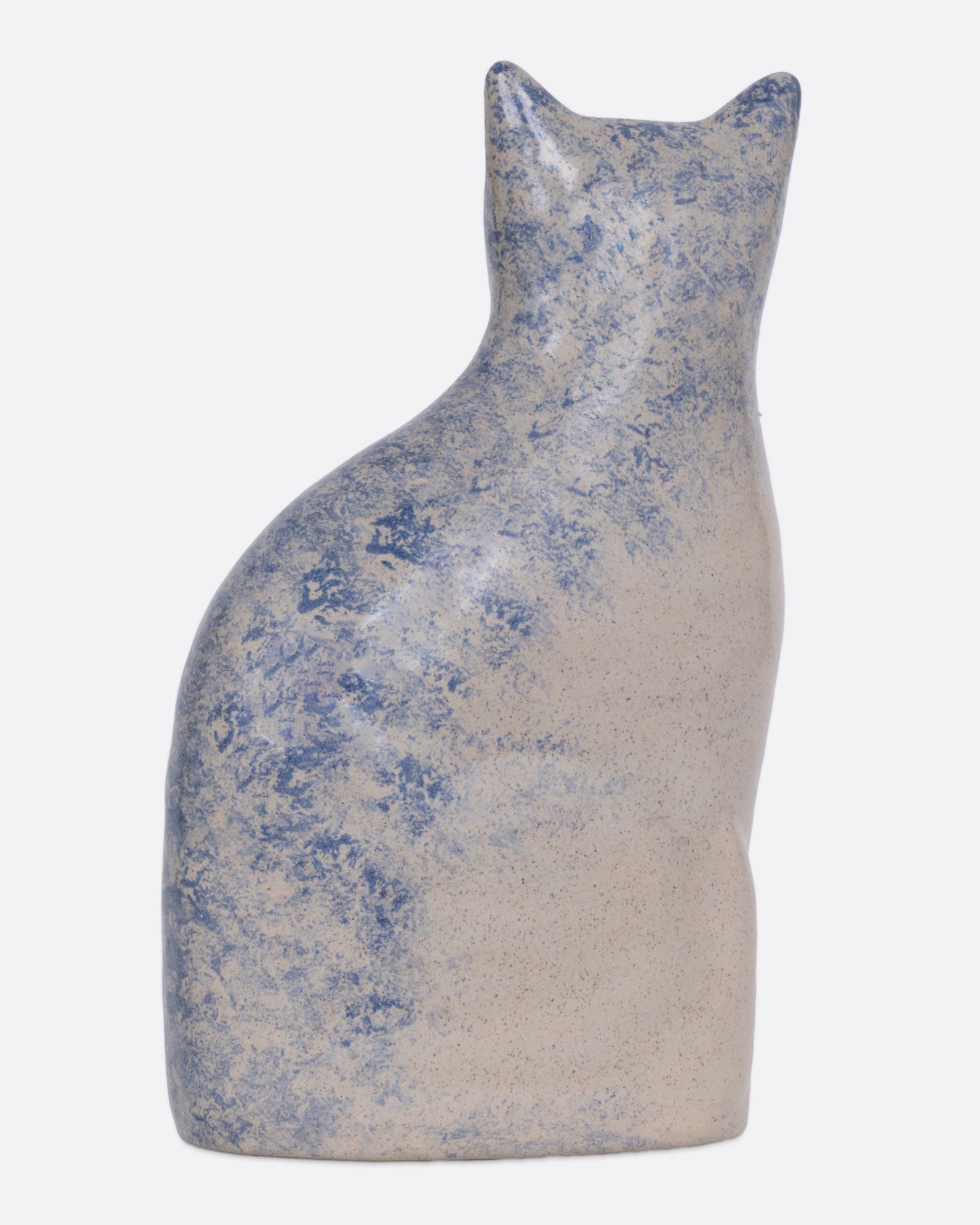 A ceramic cat figurine with blue speckles, shown from the back.
